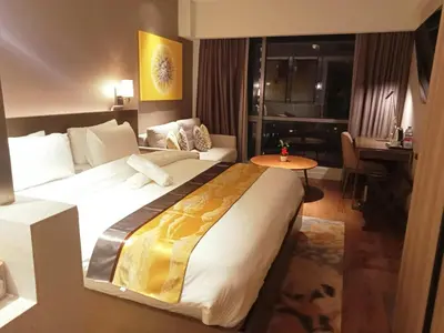 a hotel room with a large bed and a table at Novotel Executive Suite - Acqua Manila 2905 in Manila