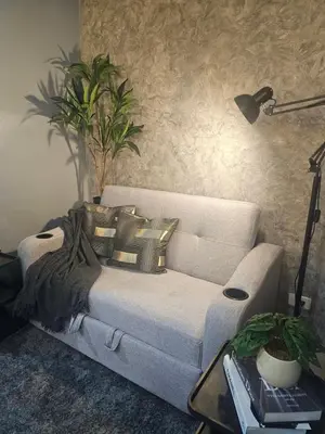 a living room with a couch with pillows on it at Sakura Suites At Mall of Asia Near Airport in Manila