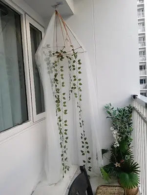 a white curtain hanging on a balcony with plants at Shore residences tower A in Manila