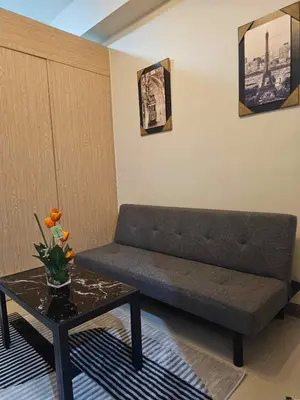a living room with a couch and a table at SMDC Field REsidences condo unit in Manila