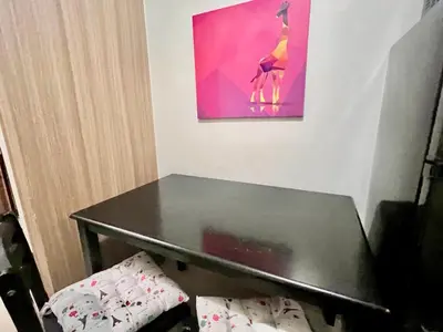 a black table in a room with a painting at MOA - Walking Distance to Mall Cheap Accommodation in Manila