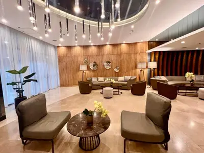 a lobby with couches and chairs and a table at MOA - Pasay Cheap Accommodation in Manila