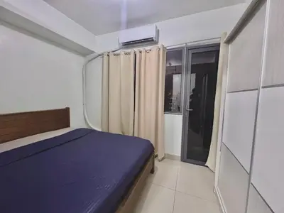 a bedroom with a blue bed and a window at MOA - Pasay Cheap Accommodation in Manila