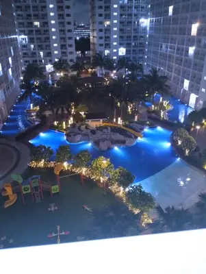 an aerial view of a large pool at night at Mall of Asia Shore Residence - Perfect Location in Manila