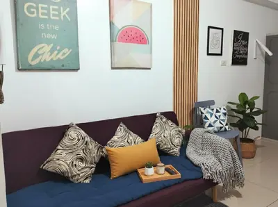 a blue couch with pillows on it in a living room at Mall Of Asia - Aseana Super Value for Money in Manila