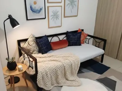 a couch with a blanket on it in a room at Mall Of Asia - Aseana Super Value for Money in Manila