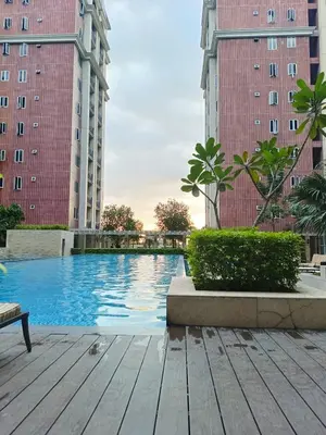 a swimming pool in the middle of two tall buildings at BP952 With Balcony and River View in Manila
