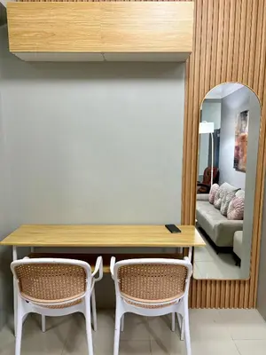 a dining room with a table and two chairs at Stylish Comfy and Cozy in Manila