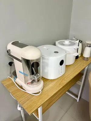 a counter with several appliances on top of it at Stylish Comfy and Cozy in Manila