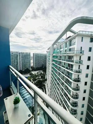 a balcony with a view of a large building at Azure Staycation By Star in Manila