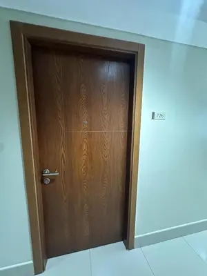 a wooden door in a room with a wall at Shell Residences pool view in Manila