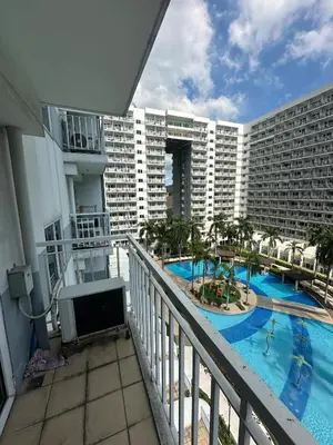 a balcony of a hotel with a swimming pool at Shell Residences pool view in Manila