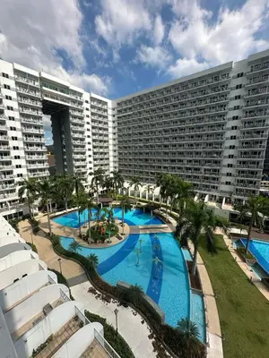 an overhead view of a large hotel with a swimming pool at Shell Residences pool view in Manila