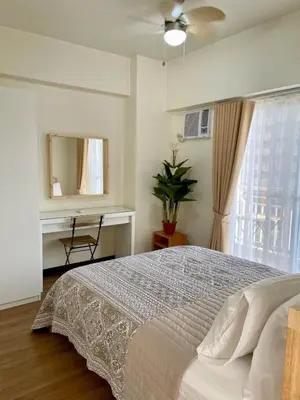 a bedroom with a bed and a mirror and a window at 5 Star Luxury Condo - Metro Manila in Manila