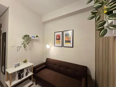 a living room with a couch and a table at 1BR Condotel with Balcony at FAME Residences #FM10 in Manila