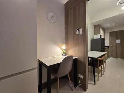 a kitchen and dining room with a table and chairs at 1BR Condotel with Balcony at FAME Residences #FM10 in Manila