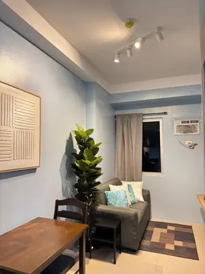 a living room with a couch and a table at D&M cosy staycation in Manila