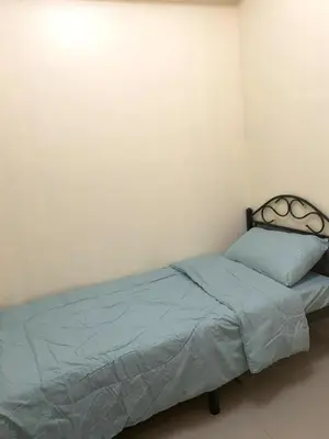a bedroom with a bed with a blue comforter at D&M cosy staycation in Manila