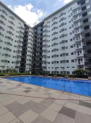 two large apartment buildings with a large swimming pool at D&M cosy staycation in Manila