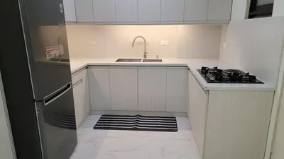 a white kitchen with a sink and a stove at Levina Place 2BR Resort inspired in Manila