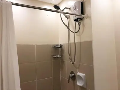 a shower in a bathroom with a shower curtain at 1 BR Condo in Quezon City at Avida New Manila in Manila