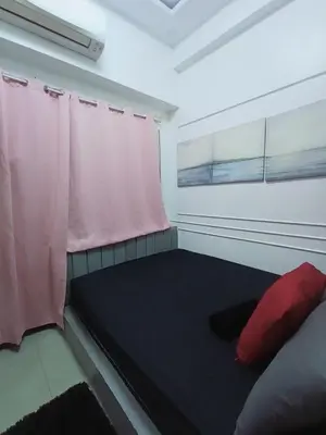 a small room with a bed and a window at Cozy room for couple and family near mall of asia in Manila