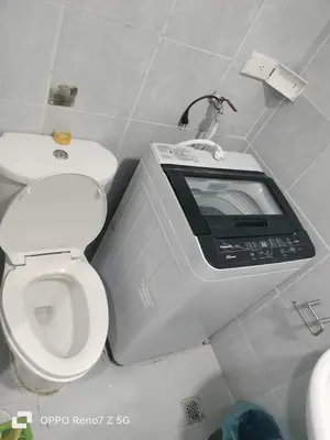 a bathroom with a toilet with a tv on it at Verlyn Place At Sea Residences Near Moa in Manila