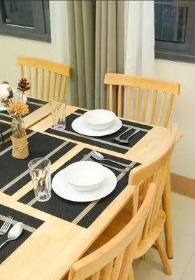 a dining room table with a black and white table cloth at Awesome Corner at Shore 3 Mall of Asia near Airport in Manila