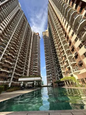 two tall buildings with a swimming pool between them at Relaxation Getaway in Manila