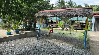 a swing set with a straw roof at Lenjawi Resort and Events Place in Bitangan
