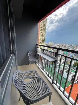 a balcony with two chairs and a view of a city at Chino Roces Makati - Free Parking - Red Residences in Manila