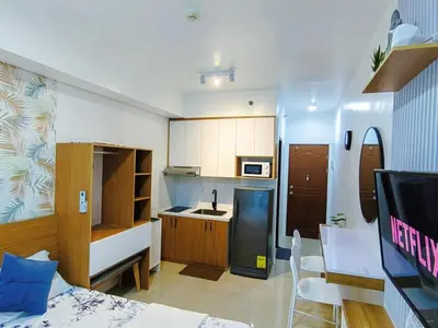 a room with a kitchen and a living room at The Beacon Condo at Makati CBD in Manila