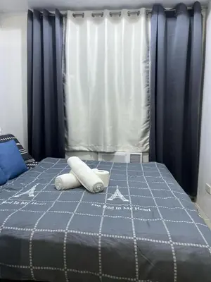 a bed with two towels on top of it at MNM Place - Sea Residence 0D in Manila