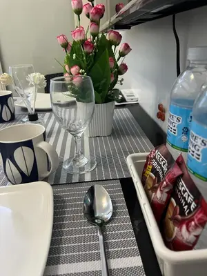 a table with a bottle of water a bowl of chips and a spoon at MNM Place - Sea Residence 0D in Manila