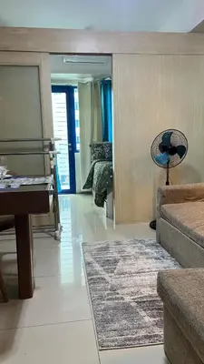 a living room with a piano and a bedroom at MNM Place - Sea Residence 5A in Manila