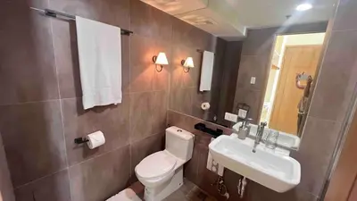 a bathroom with a toilet and a sink at 3 Bedroom Beautiful and Spacious Penthouse in Makati in Manila