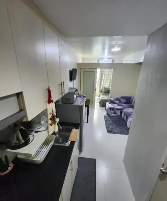 a room with a kitchen and a living room at MNM Place - Sea Residence 9A in Manila