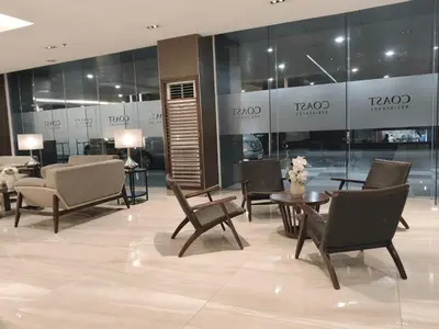 a lobby with chairs and tables in a building at 2 Br Condo Apartment near PICC, CCP, WTC & Star City at Coast Residences, Pasay City in Manila