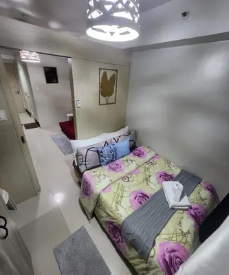 a bedroom with a bed in a room at MNM Place - Sea Residence 0A in Manila