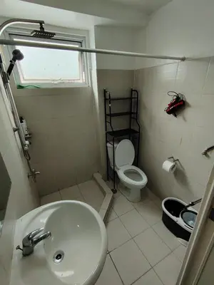 a bathroom with a sink and a toilet at MNM Place - Sea Residence 0F in Manila