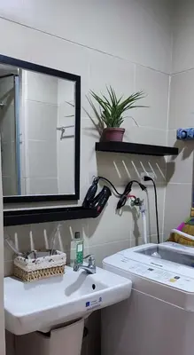 a bathroom with a sink and a mirror at Condo Staycation Fame Residences T2 Mandaluyong Philippines in Manila