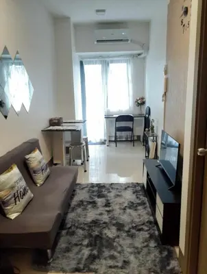 a living room with a couch and a table at Condo Staycation Fame Residences T2 Mandaluyong Philippines in Manila