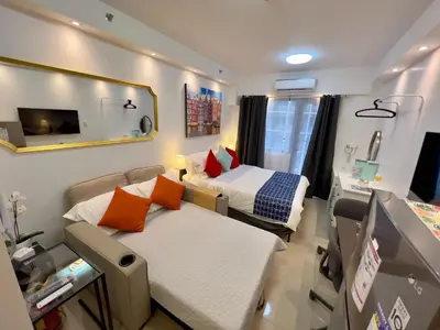 a hospital room with two beds and a mirror at The Grand Staycation at MOA - Unit 7102 Hotel-like in Manila