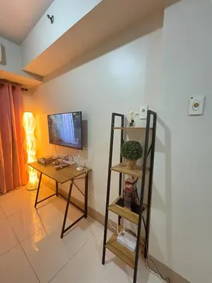 a room with a desk and a computer on a wall at Cozy Haven 2 in Manila
