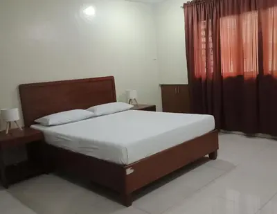 a bed in a bedroom with two night stands and a bed sidx sidx sidx sidx at Joyce Apartelle San Juan in Manila