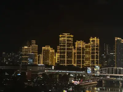 a lit up city skyline at night with at 2BR Resort Type condo w city view Sheridan in Manila