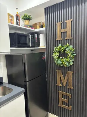 a kitchen with a black refrigerator and a sign that reads firemite at The Villa at Azure South - Bahamas in Manila