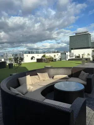 a patio with a couch and a table at The Hmlet Manila, Near Poblacion Makati Nightlife in Manila