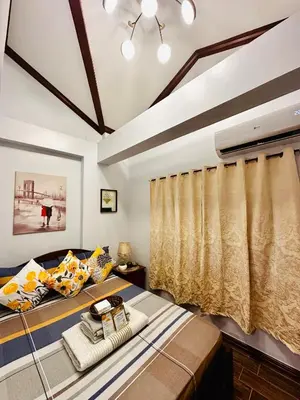 a bedroom with two beds and a window at Isabelle Garden Villas Condominium Paranaque City in Manila