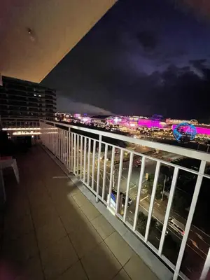 a balcony with a view of a city at night at Shell Residence in Manila